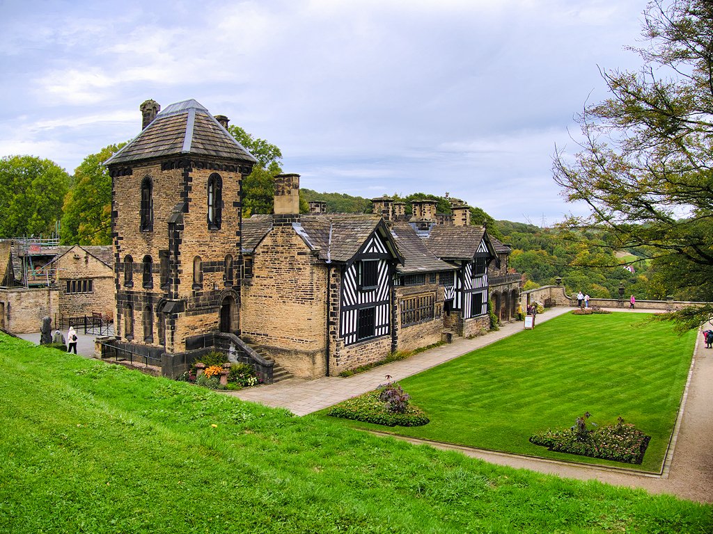 Shibden Hall’s stone tower and timber-framed facade beside green lawns